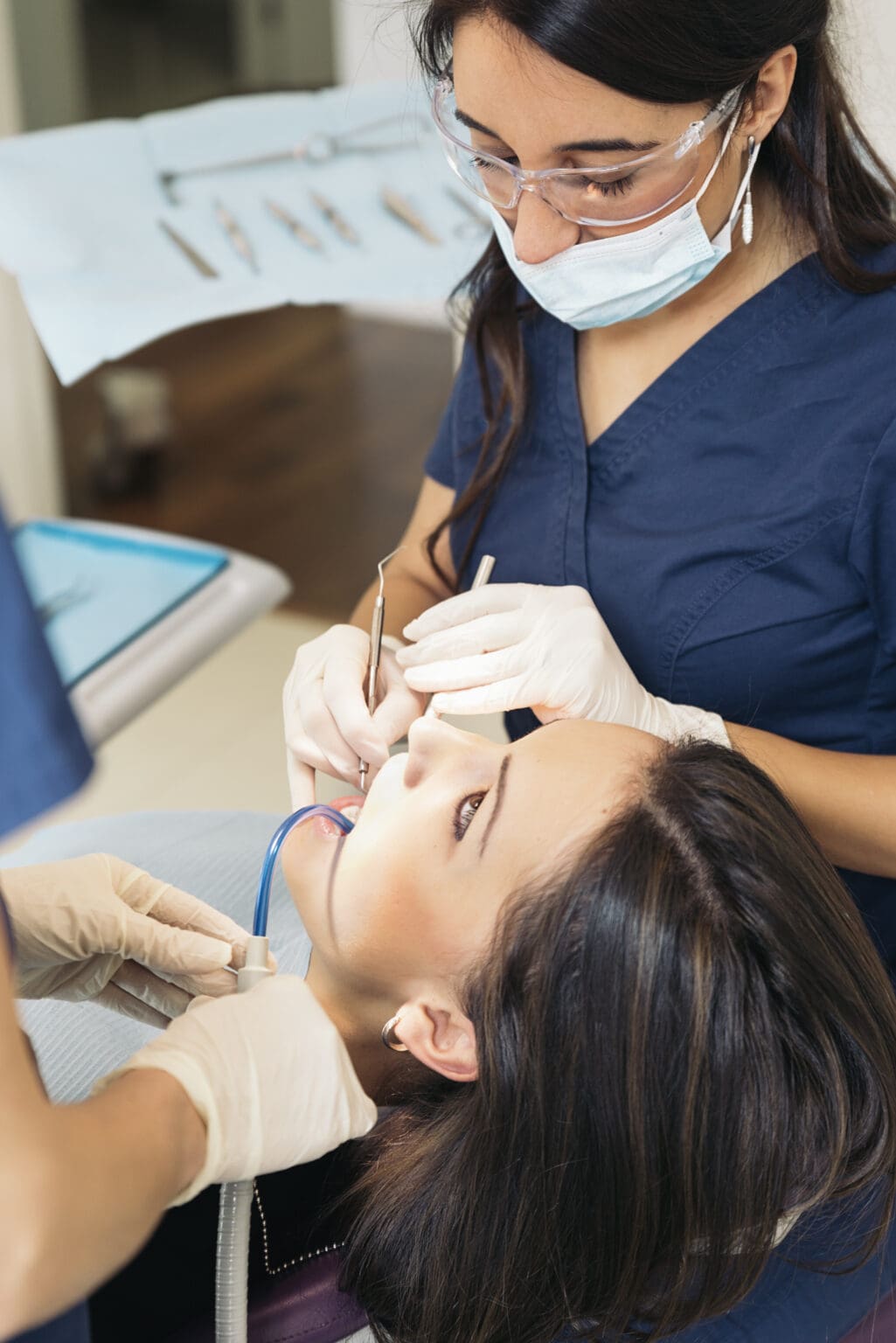 Dentists with a patient during a dental intervention. Medical Concept.